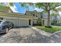 Inviting townhome featuring a two-car garage, neutral exterior, and well-maintained landscaping at 7576 Plantation Cir, Bradenton, FL 34201