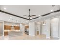 Bright, open-concept living area with neutral walls and ceilings that feature designer lighting at 8936 Artisan Way, Sarasota, FL 34240