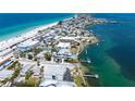 Stunning aerial view of property showcasing beach access, marina, and surrounding coastal community at 901 Gulf S Dr # 14, Bradenton Beach, FL 34217