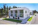 Contemporary home with large windows, a clean white exterior, and well-maintained landscaping at 941 N Osprey Ave, Sarasota, FL 34236
