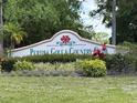 Peridia Golf & Country Club signage with manicured landscaping and colorful flowering bushes at 4812 Sand Trap E Cir, Bradenton, FL 34203