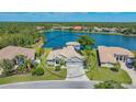 Aerial view showcasing waterfront property with lush landscaping and stunning lake views at 1085 Mallard Marsh Dr, Osprey, FL 34229