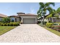 Charming home featuring a paved driveway and beautiful landscaping at 12740 Del Corso Loop, Lakewood Ranch, FL 34211