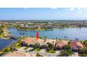 Aerial view of community homes with lake, bridge, and pool amenities; prime real estate location at 13724 Quinta St, Venice, FL 34293