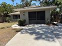 Charming one-story home with a well-maintained lawn and a screened two-car garage, offering curb appeal at 1461 17Th St, Sarasota, FL 34234