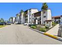 Condominium building with manicured landscaping and ample parking spaces at 1624 Stickney Point Rd # 24-206, Sarasota, FL 34231