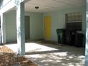 Open carport with overhead light, storage, and space for parking with durable concrete flooring at 1805 9Th W St, Palmetto, FL 34221