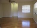 Open-concept living room featuring hardwood floors and natural light from a large window at 1805 9Th W St, Palmetto, FL 34221