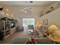 Spacious living room with large windows overlooking the pool, offering a seamless indoor-outdoor living experience at 18513 Placid Ave, Port Charlotte, FL 33948