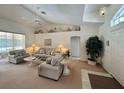 Inviting living room with neutral tones, vaulted ceiling, and an abundance of natural light at 18513 Placid Ave, Port Charlotte, FL 33948