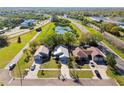 Aerial view showcases residential homes, green landscape, pond and roads; great neighborhood appeal at 206 Bedford St, Oldsmar, FL 34677
