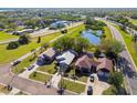 Aerial view of well-kept homes, lush greenery, pond, and the convenience of the nearby highway at 206 Bedford St, Oldsmar, FL 34677