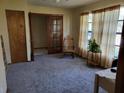 Cozy living room features plush carpeting, a ceiling fan, and large windows that let in plenty of natural light at 22116 26Th E Ave, Bradenton, FL 34211