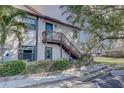 Exterior of the condo building showcasing its well-maintained landscaping and private entry stairway at 2825 74Th W St, Bradenton, FL 34209
