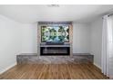 Modern fireplace featuring a flat screen TV, sound bar, and beautiful marble stone accents at 2929 Siesta Dr, Venice, FL 34293