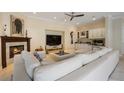 Open-concept living space with a fireplace, a TV, and custom cabinets with a beverage bar at 340 Osprey Point Dr, Osprey, FL 34229