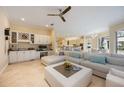Inviting living room with a large white sectional, custom cabinets, and an open floor plan at 340 Osprey Point Dr, Osprey, FL 34229