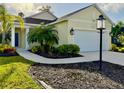 Charming one-story home featuring a well-manicured lawn and beautiful landscaping at 3706 Shimmering Oaks Dr, Parrish, FL 34219