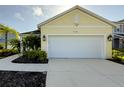 Lovely garage with a driveway and well-maintained landscaping around the home at 3706 Shimmering Oaks Dr, Parrish, FL 34219