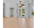 Open foyer with high ceilings, tiled floors, and a view to the front yard through glass double doors at 4713 Sweetmeadow Cir, Sarasota, FL 34238