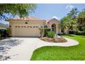 Charming home featuring a clay tile roof, attached two-car garage, and a well-manicured front lawn at 4713 Sweetmeadow Cir, Sarasota, FL 34238
