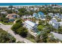 Aerial view of a coastal home boasting a pool, lush landscaping, and proximity to the beach and ocean at 497 Island Cir, Sarasota, FL 34242