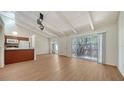 Open-concept living space with vaulted ceiling and wood-look floors at 500 N Jefferson Ave # 5, Sarasota, FL 34237