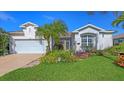 Charming single-story home boasts a well-kept lawn, two-car garage, and colorful landscaping at 5022 46Th W St, Bradenton, FL 34210