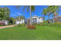 Attractive one-story home with a two-car garage, green lawn, and lush tropical landscaping at 5022 46Th W St, Bradenton, FL 34210