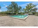 Community swimming pool with a paved sunbathing area and a clear blue swimming pool at 5623 Palm Aire Dr, Sarasota, FL 34243