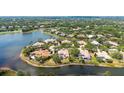 Beautiful aerial view of waterfront property in an upscale community, surrounded by mature trees and lush landscaping at 7319 Westminster Ct, University Park, FL 34201
