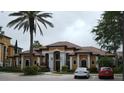Clubhouse featuring manicured landscaping, tile roof, and parking at 8325 38Th Street E Cir # 101, Sarasota, FL 34243