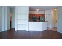 Open-concept living area with dark wood floors flows into a modern kitchen with stainless steel appliances at 8325 38Th Street E Cir # 101, Sarasota, FL 34243