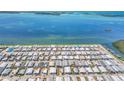 High aerial view of a dense waterfront community near a boat harbor and a waterway at 10315 Cortez W Rd # 24H, Bradenton, FL 34210