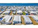 Expansive aerial view of a waterfront community with white rooftops and lush palm trees at 10315 Cortez W Rd # 24H, Bradenton, FL 34210
