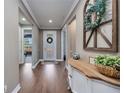 Inviting entryway featuring hardwood floors, decorative accents, and abundant natural light at 11092 58Th Street Cir E, Parrish, FL 34219