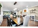 Spacious living room with a fireplace, modern lighting, and comfortable seating at 11092 58Th Street Cir E, Parrish, FL 34219