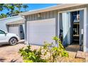 Exterior shot of a one-car garage featuring a white door and stylish brick paving at 1235 Dockside Place # 108, Sarasota, FL 34242