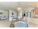 Dining area showcases a round wood table, chandelier lighting, and views to the kitchen and living room at 135 Sweet Tree St, Bradenton, FL 34212