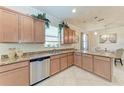 Kitchen with granite countertops, stainless steel appliances, wooden cabinetry, and views of the dining area at 135 Sweet Tree St, Bradenton, FL 34212