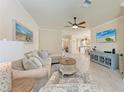 Bright living room featuring tile floors, comfortable seating, and a view into the kitchen and dining area at 135 Sweet Tree St, Bradenton, FL 34212