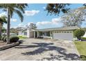 Charming home boasts a well-manicured lawn and a spacious driveway leading to a convenient two-car garage at 1440 S Keene Rd, Clearwater, FL 33756