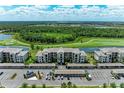 Scenic aerial view of condo community with golf course, lake and covered parking at 18028 Gawthrop Dr # 203, Bradenton, FL 34211