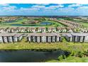 Beautiful aerial view of a condo community with a golf course and surrounding pond at 18028 Gawthrop Dr # 203, Bradenton, FL 34211