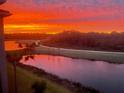Beautiful sunset view over the water and golf course with vibrant orange and red colors at 18028 Gawthrop Dr # 406, Bradenton, FL 34211