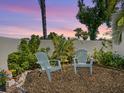 Cozy backyard featuring two chairs and a small table, creating a perfect spot for relaxation and outdoor enjoyment at 2720 Herwald St, Sarasota, FL 34231