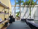 Bright sunroom with glass ceiling and walls, showcasing modern furniture and access to the outdoor patio at 2720 Herwald St, Sarasota, FL 34231