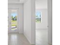 Bright foyer with neutral tile flooring and a view of the neighborhood through the glass front door at 27407 Deep Creek Blvd, Punta Gorda, FL 33983