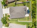 A bird's eye view of the property, featuring a fenced backyard and a covered patio area at 2819 130Th E Ave, Parrish, FL 34219