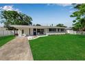 Charming one-story home featuring a well-maintained lawn, white rock landscaping, and a cozy porch swing at 3101 Bay St, Sarasota, FL 34237
